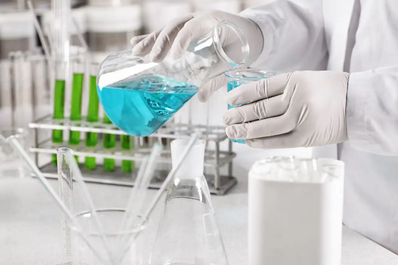 chemical being poured into a test tube